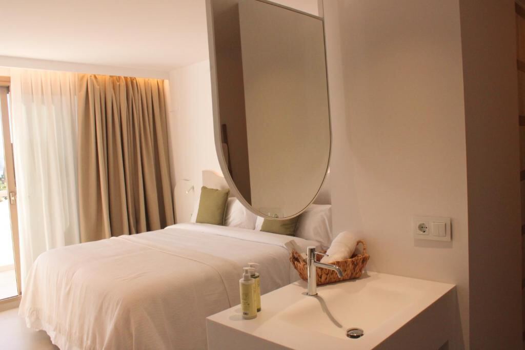 Suite with a king bed and mirror at the boutique hotel